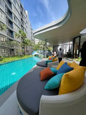a group of pillows on a couch next to a pool at Dcondo Reef Modern Condos 1&2 Bedrooms in Kathu