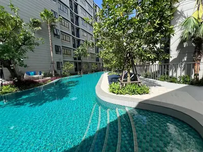 a swimming pool with a tree in the middle of a building at Dcondo Reef Modern Condos 1&2 Bedrooms in Kathu
