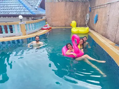 a man and two girls in a swimming pool at Phuket Patong Plan B house in Patong Beach