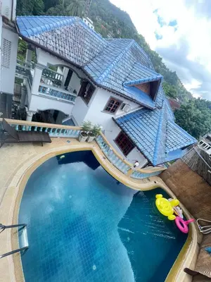 an aerial view of a building with a swimming pool at Phuket Patong Plan B house in Patong Beach