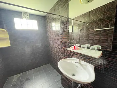 a bathroom with a sink and a mirror at Phuket Patong Plan B house in Patong Beach