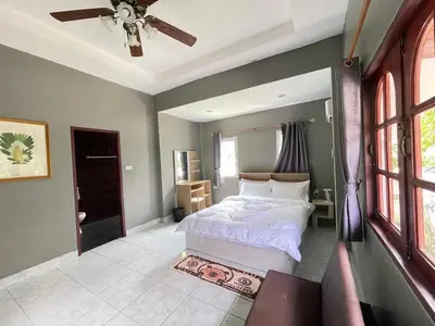 a bedroom with a bed and a ceiling fan at Phuket Patong Plan B house in Patong Beach