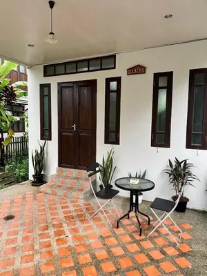 a patio with a table in front of a building at 103-25 Kathu Waterfall in Phuket Town
