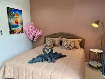 a bed with a blue bow on it in a bedroom at TN KAMALA Room For Rent in Kamala Beach