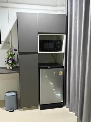 a small refrigerator with a microwave on top of it at TN KAMALA Room For Rent in Kamala Beach