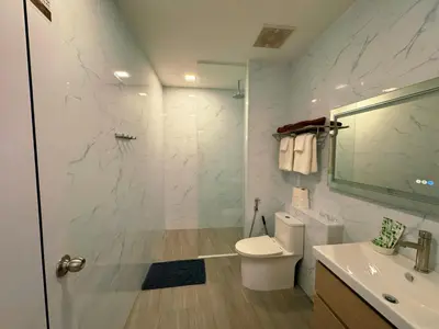 a bathroom with a shower and a toilet and a sink at Ground Floor Zen Space Kamala in Kamala Beach