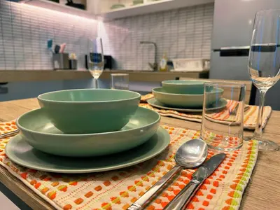 a table with two bowls and silverware on a table at Ground Floor Zen Space Kamala in Kamala Beach