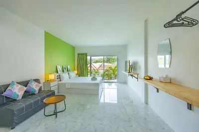 a living room with a couch and a bed at Karon Hotel at 22 in Karon Beach