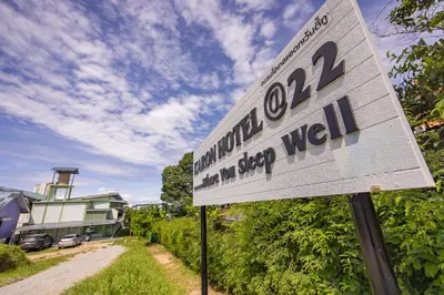 a sign for a building on a dirt road at Karon Hotel at 22 in Karon Beach