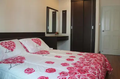 a bedroom with a bed with red roses on it at Nice Apartment large pool in nice residence central Patong beach in Patong Beach