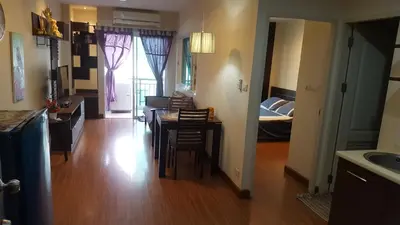 a kitchen and living room with a table and a bed at Nice Apartment large pool in nice residence central Patong beach in Patong Beach