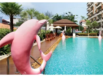 a pink dolphin drinking water from a pool at Nice Apartment large pool in nice residence central Patong beach in Patong Beach