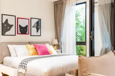 a bedroom with a bed with pictures of cats at Title Halo Life in Yellow 40m2 King Bed Pool in Nai Yang Beach