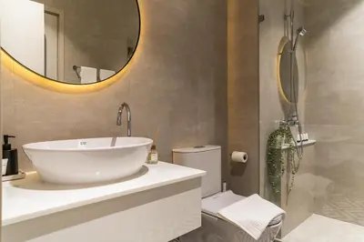 a bathroom with a sink and a mirror and a toilet at Title Halo Life in Yellow 40m2 King Bed Pool in Nai Yang Beach