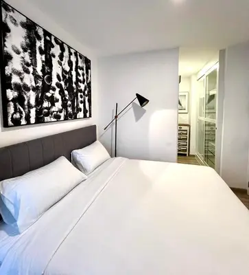 a bedroom with a large white bed and a lamp at Zcape 2 Boat Avenue, Laguna Brand New Renovated One bedroom Apartment with the Mountain View in Bang Tao Beach