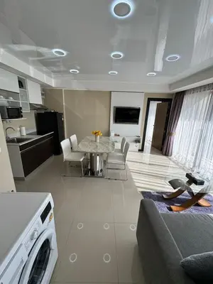 a kitchen and living room with a table and chairs at Apartment Mai Khao Beach in Mai Khao Beach