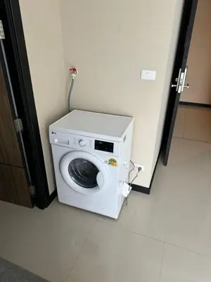 a washing machine sitting in the corner of a room at Apartment Mai Khao Beach in Mai Khao Beach