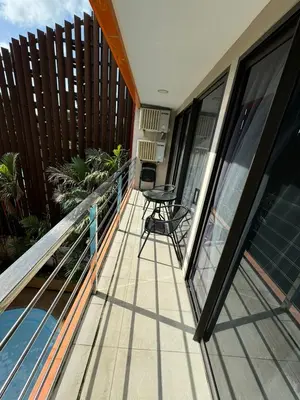 a balcony with a table and chairs on it at Apartment Mai Khao Beach in Mai Khao Beach