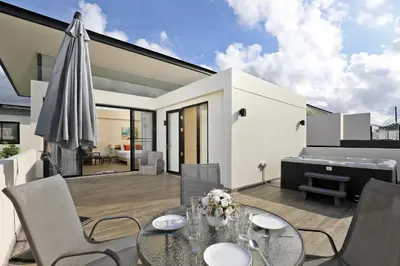 a patio with a glass table and a piano at 5 bdr Pool Villa Bang Tao Beach in Laguna Phuket
