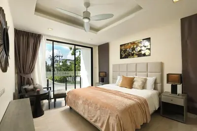 a bedroom with a bed and a large window at 5 bdr Pool Villa Bang Tao Beach in Laguna Phuket