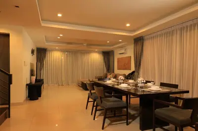 a dining room with a long table and chairs at 5 bdr Pool Villa Bang Tao Beach in Laguna Phuket
