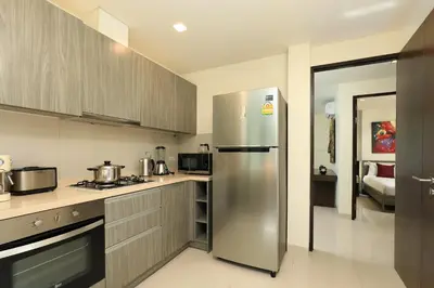a kitchen with a stainless steel refrigerator at 5 bdr Pool Villa Bang Tao Beach in Laguna Phuket