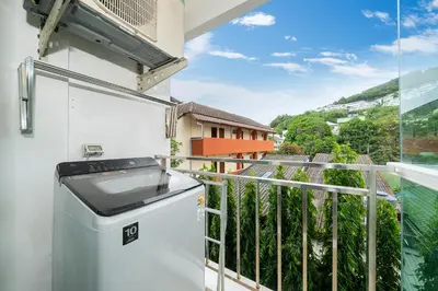 a balcony with a stove and a view at Beach Life & Surf Thrills, Stay at Kata Suite 8-132 in Kata Oasis Residence in Kata Beach