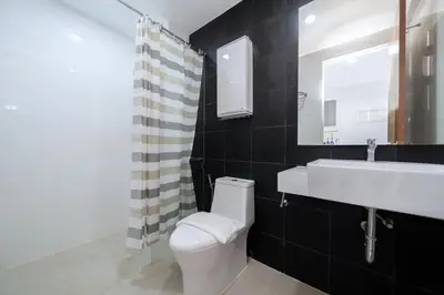 a bathroom with a white toilet and a sink at Beach Life & Surf Thrills, Stay at Kata Suite 8-132 in Kata Oasis Residence in Kata Beach
