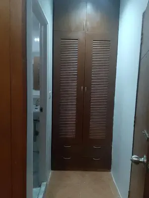 a bathroom with two brown lockers and a mirror at Lucky Guest house in Karon Beach