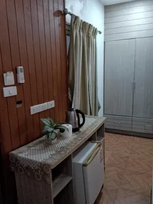 a kitchen with a counter with a sink and a refrigerator at Lucky Guest house in Karon Beach