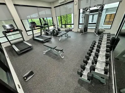 a gym with several treadmills and machines in it at Super Naiyang Title 1Bdr 600m to beach in Nai Yang Beach
