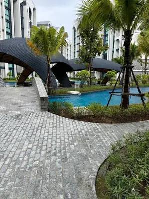 a walkway with palm trees in front of a building at Super Naiyang Title 1Bdr 600m to beach in Nai Yang Beach
