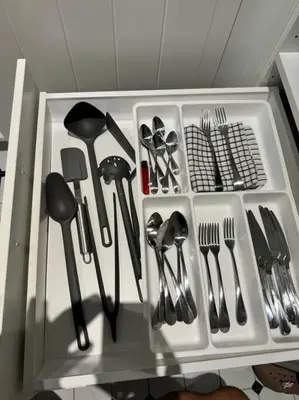 a white drawer filled with utensils on a shelf at Super Naiyang Title 1Bdr 600m to beach in Nai Yang Beach