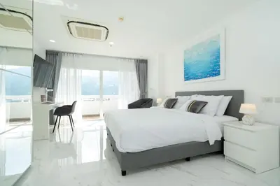 a bedroom with a large bed and a bathroom at Patong Tower Brand 1-Bedroom apartment mountain view , Near Beach in Patong Beach