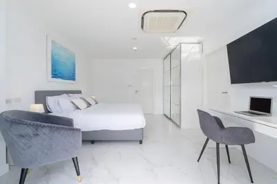a bedroom with a bed and a table and chairs at Patong Tower Brand 1-Bedroom apartment mountain view , Near Beach in Patong Beach