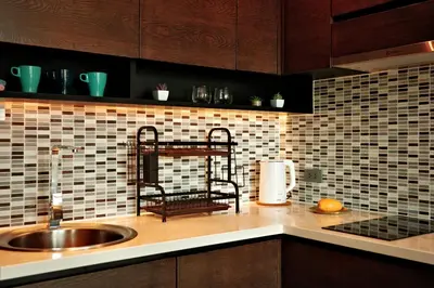 a kitchen with a sink and a tiled wall at Kamala CityGate Apartments in Kamala Beach