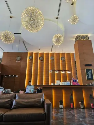 a man sitting at a desk in a lobby at Kamala CityGate Apartments in Kamala Beach