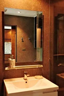 a bathroom with a sink and a large mirror at Kamala CityGate Apartments in Kamala Beach