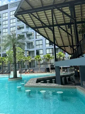 a large swimming pool with a large building at Kamala CityGate Apartments in Kamala Beach