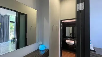 a bathroom with a sink and a mirror at Bulan Anda Resort in Ban Hua Laem