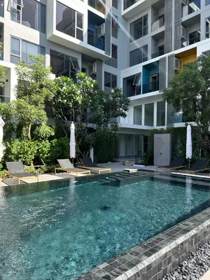 a swimming pool in front of a building at Laguna Lakeside in Bang Tao Beach