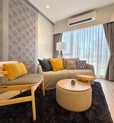 a living room with a couch and a table at Laguna Lakeside in Bang Tao Beach