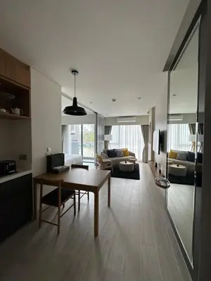 a living room with a table and a couch at Laguna Lakeside in Bang Tao Beach