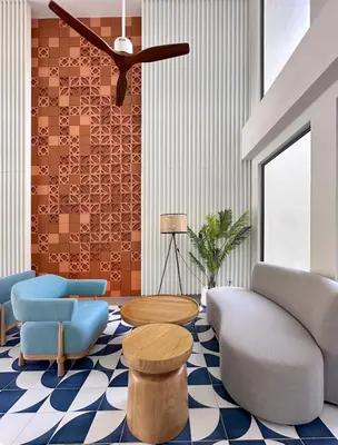 a living room with chairs and tables and a ceiling fan at Laguna Lakeside in Bang Tao Beach