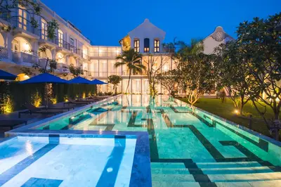 a swimming pool in front of a building at night at Little Nyonya Hotel in Phuket Town