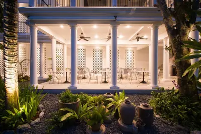 a courtyard with tables and chairs in a building at Little Nyonya Hotel in Phuket Town