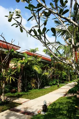 a path in front of a building with trees at Bida Daree Resort in Ao Nang Beach