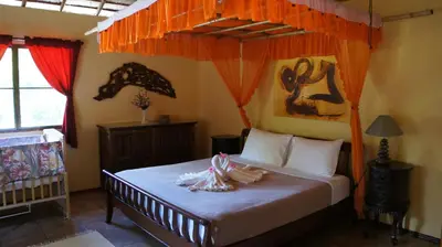 a bedroom with a bed with an orange canopy at Cliffside Lagoon Villa in Ao Nang Beach