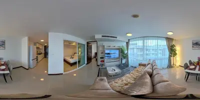 a living room with a couch and a tv at The Kris Residence Two Bedrooms Apartment in Patong Beach