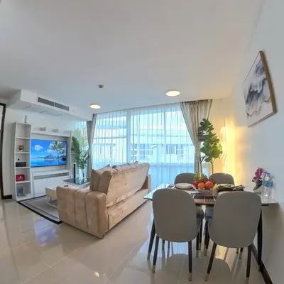 a living room with a couch and a table at The Kris Residence Two Bedrooms Apartment in Patong Beach